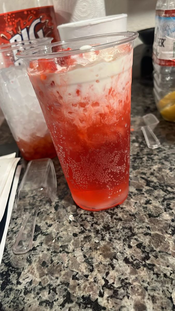 Red sparkly dirty soda with fresh fruit garnish
