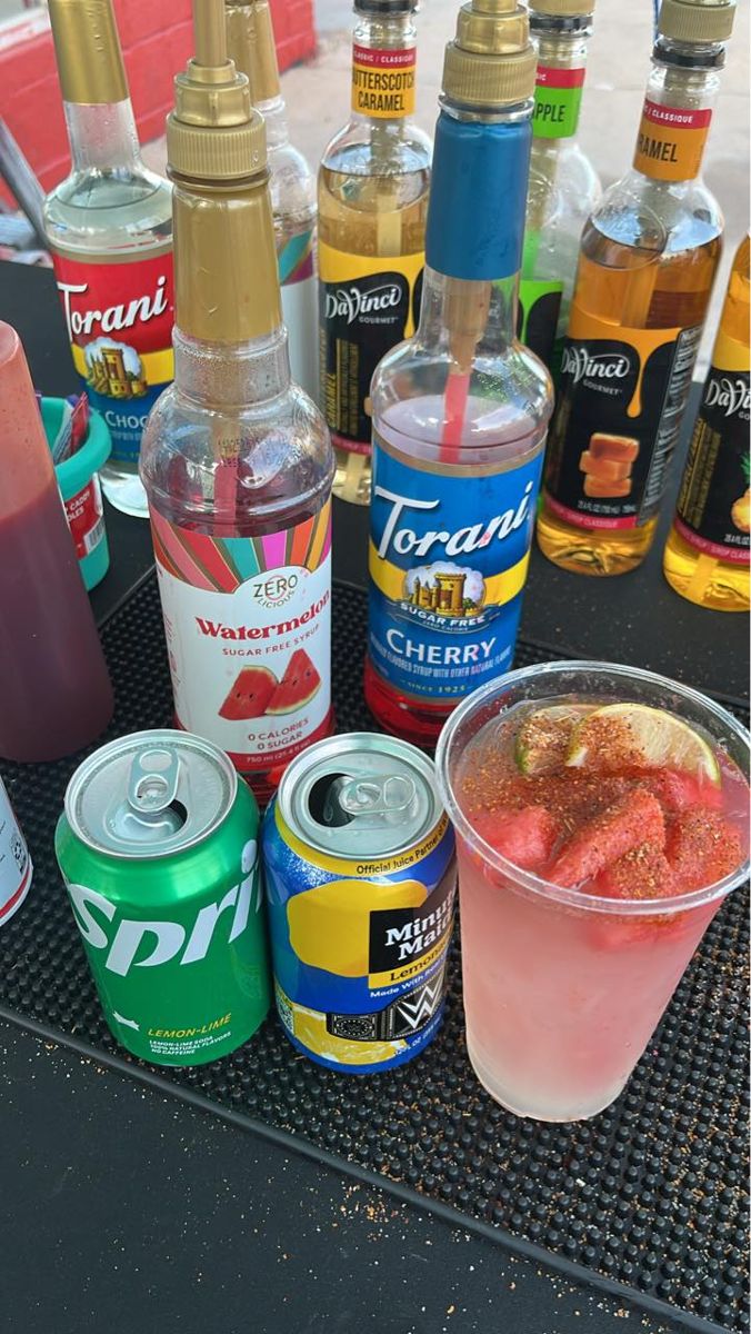 Watermelon dirty soda setup with flavor syrup bottles
